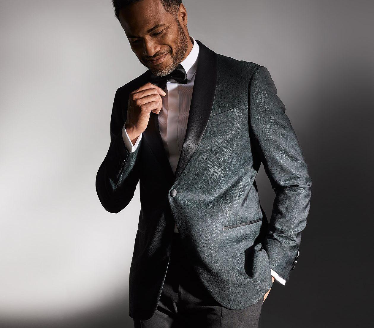 male model wearing suit and bow tie