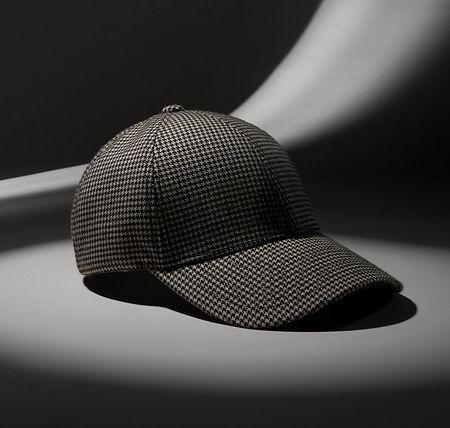 checkered baseball cap displayed on grey backdrop