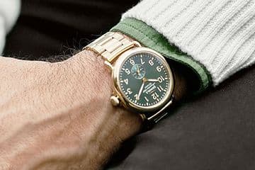 Man wearing a gold Shinola watch