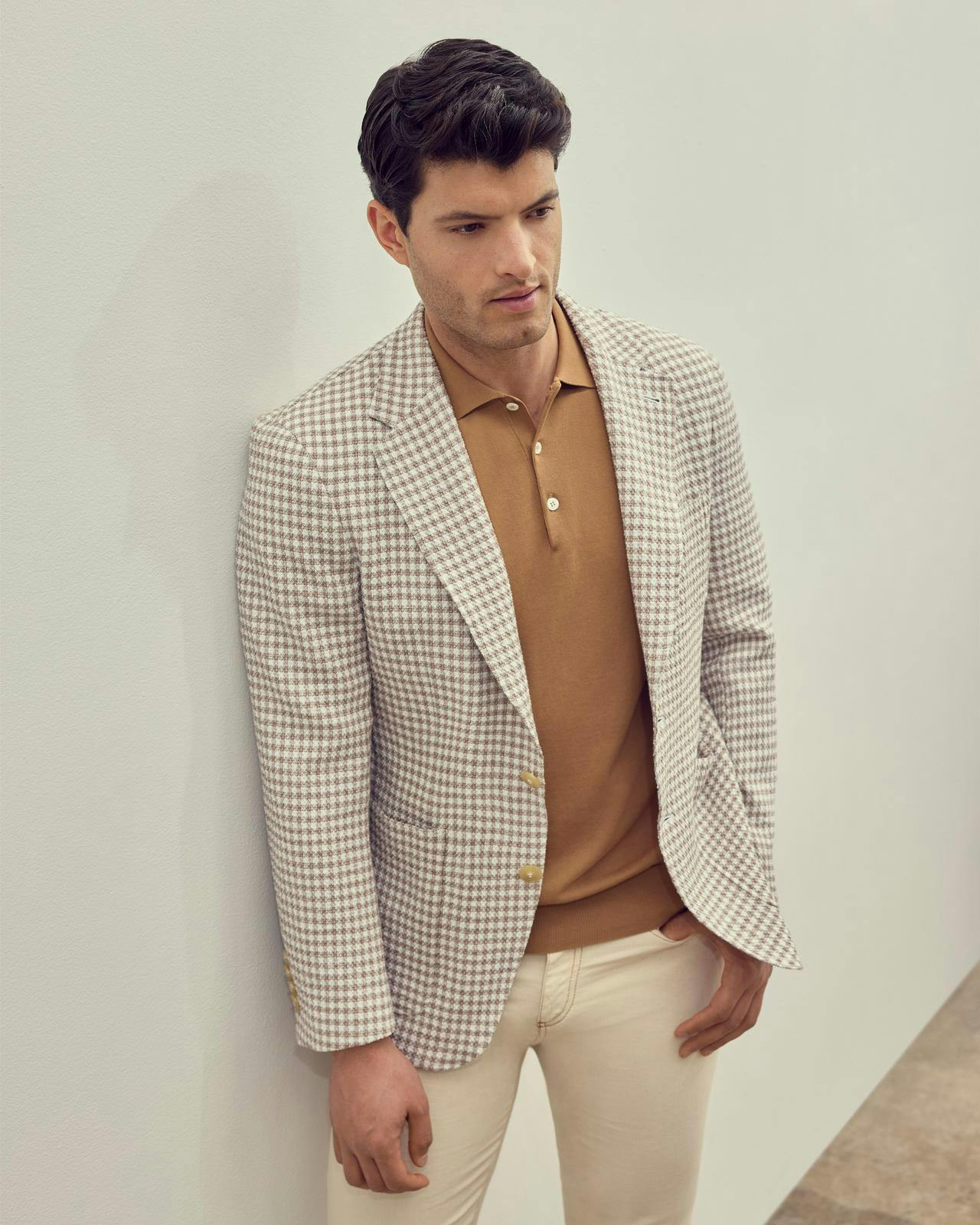 a male model in a mustard polo with a sports jacket