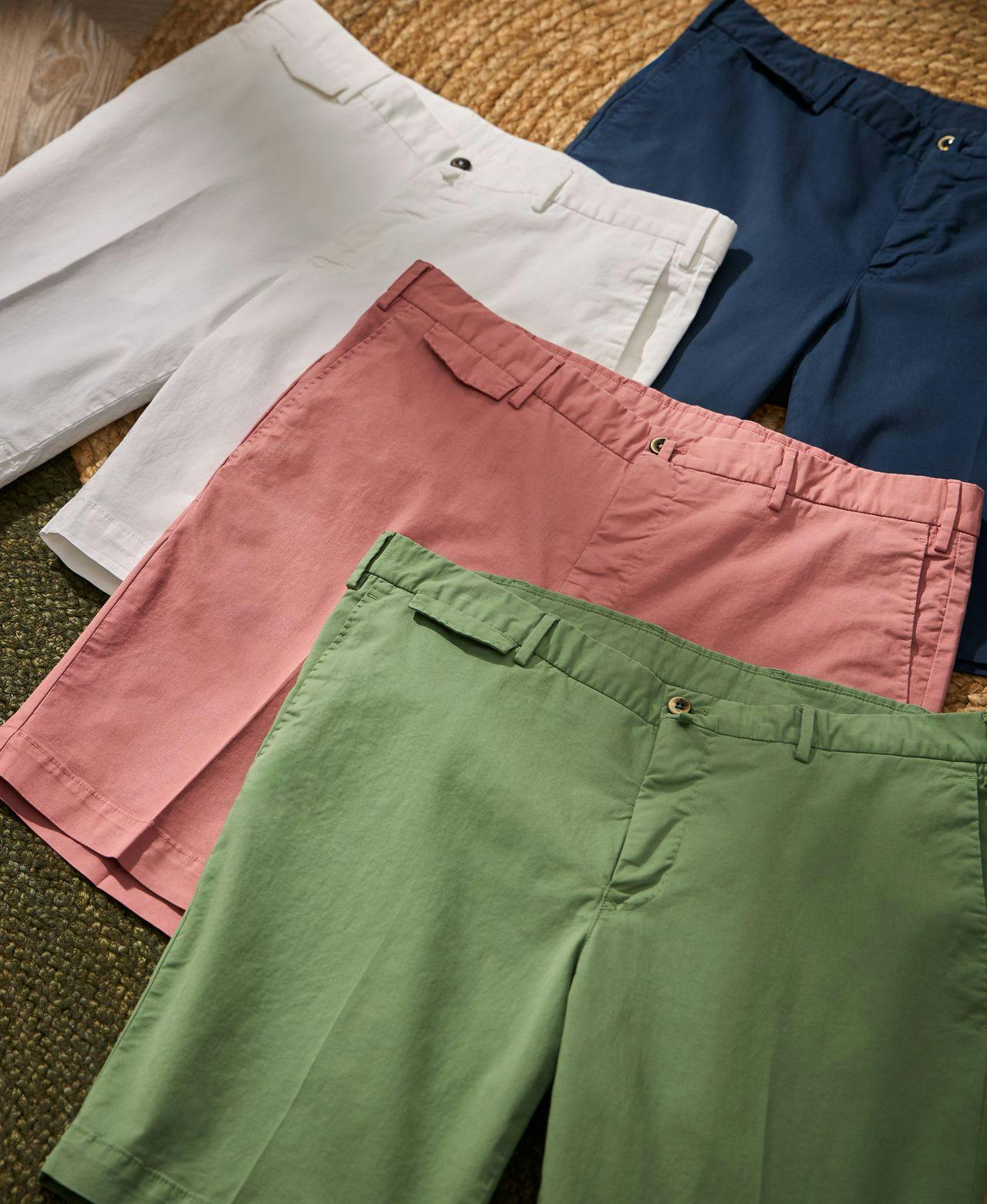 four different coloured shorts displayed on carpet