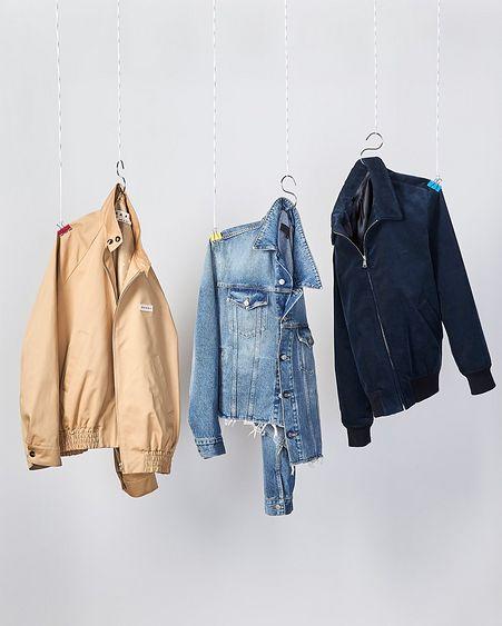 three floating jackets on hangers on grey backdrop