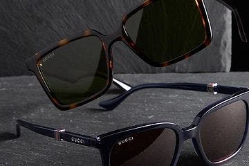 two sunglassses displayed on rock