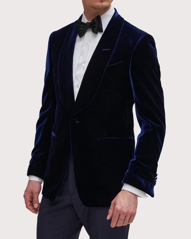 Elegant male model wearing TOM FORD's velvet and cupro mid-blue cocktail jacket.