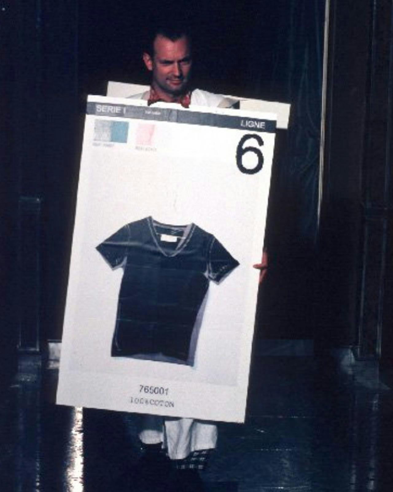 male holding a sign with a black t-shirt