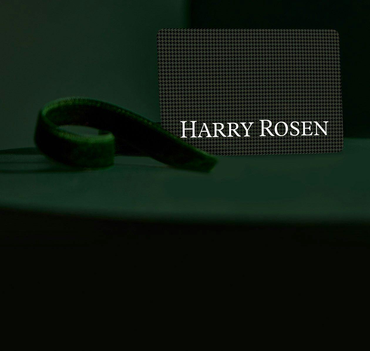 harry rosen gift bags and male hand holding harry rosen gift card over cash desk