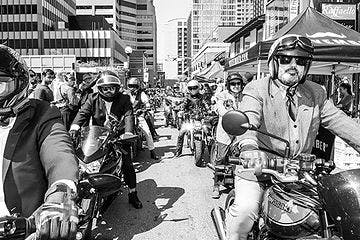group of men on motorcyles in the city