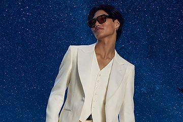 man wearing white suit with stars in background