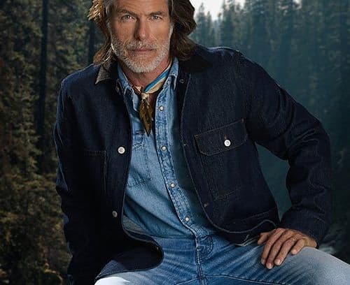 Male model wearing jean jacket, jeans and neck scarf representing 1990s style