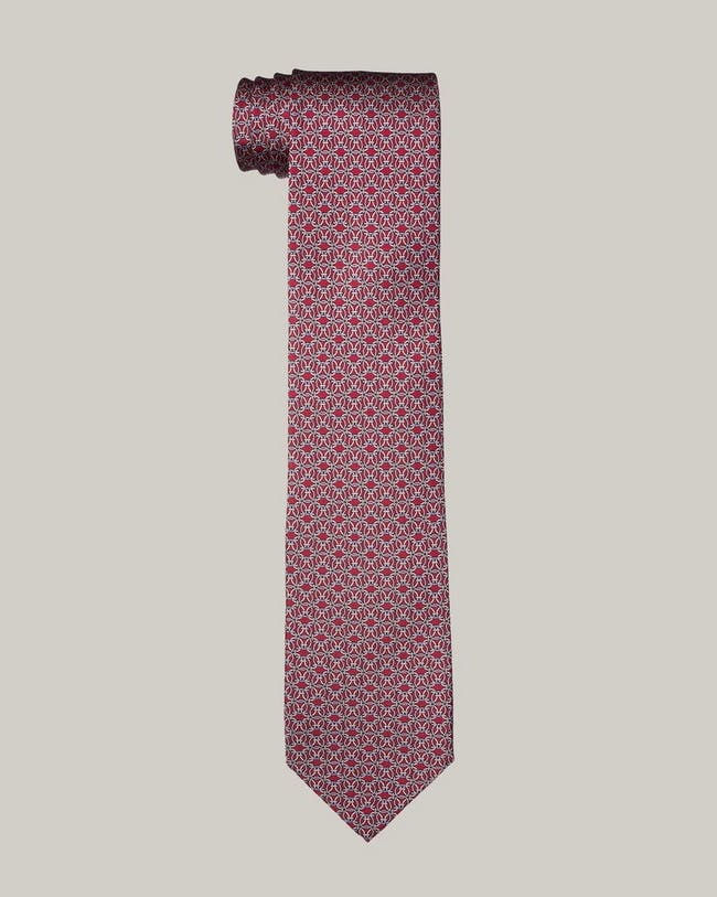 A pink tie with a red pattern on it